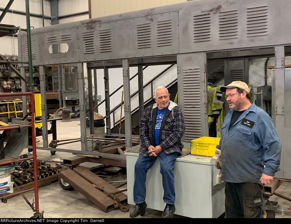 2 SMS employees talking shop.